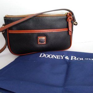Dooney & Bourke Small black pebbled leather bag with tan trim.